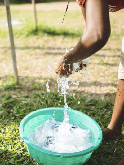 Holistic Haitian Alliance | community strengthening programs water in a bucket