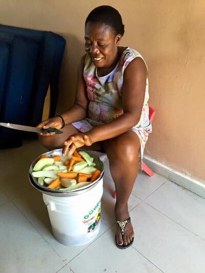 Holistic Haitian Alliance | community strengthening programs Haitian woman cutting up vegetables