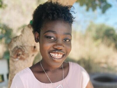 Holistic Haitian Alliance | community strengthening smiling Haitian woman