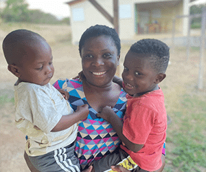 Holistic Haitian Alliance | Children & Family smiling Haitian mother and two young children
