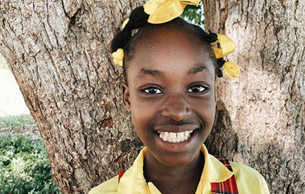 Holistic Haitian Alliance | get involved cta support a student Haitian girl smiling