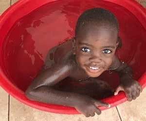 Holistic Haitian Alliance | trauma care young smiling Haitian child